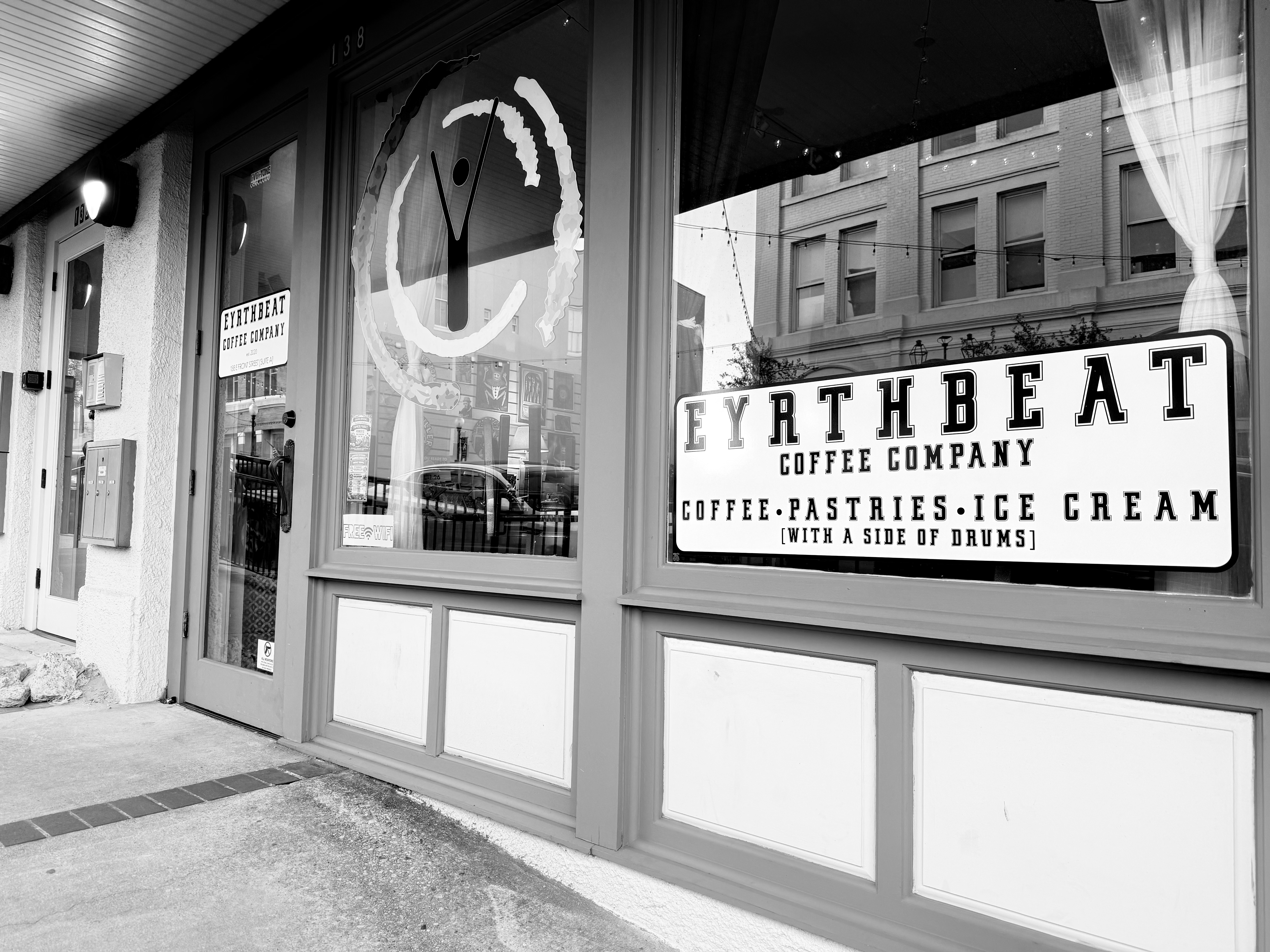 Black-and-white view of the eYrthBeat Coffee Company storefront
